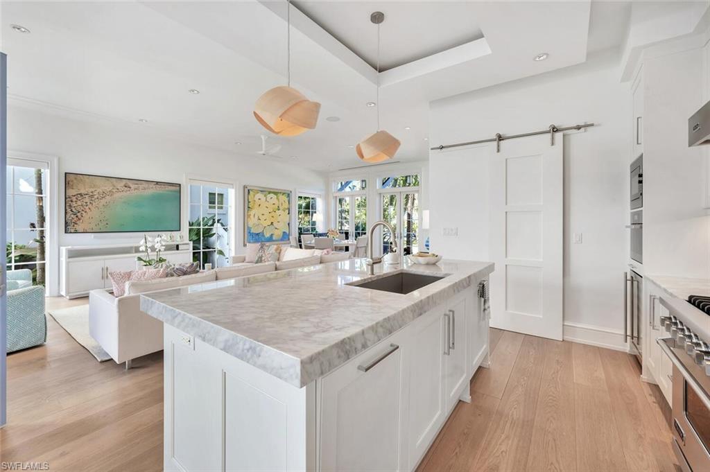 982 9th Avenue South Naples, FL 34102 - Photo 11 of 48 a kitchen with stainless steel appliances granite countertop a sink and a stove