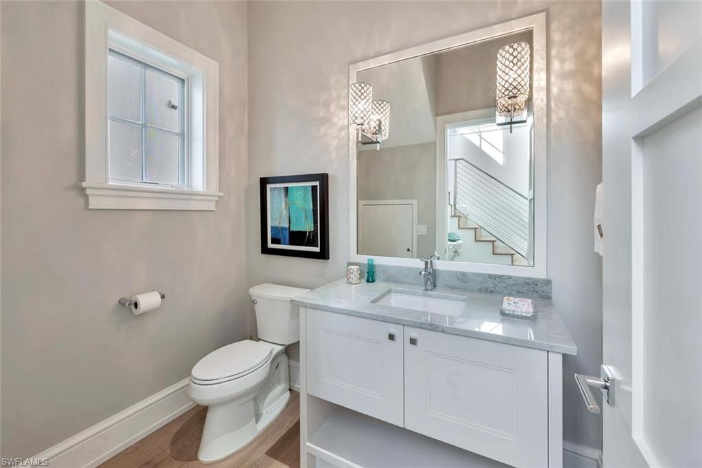 982 9th Avenue South Naples, FL 34102 - Photo 13 of 48 a bathroom with a toilet a sink and mirror