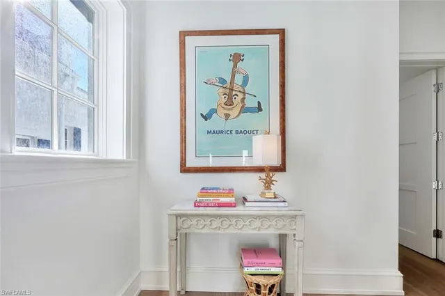 a room with a table and painting on the wall