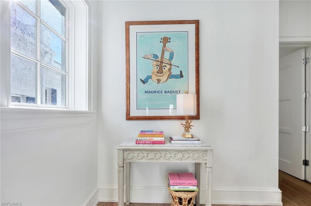 982 9th Avenue South Naples, FL 34102 - Photo 15 of 48 a room with a table and painting on the wall