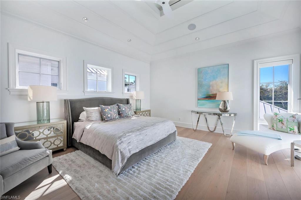 982 9th Avenue South Naples, FL 34102 - Photo 16 of 48 a bedroom with a large bed and a couch