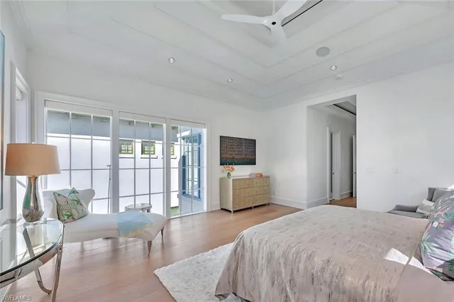 a bedroom with a large bed and a flat screen tv