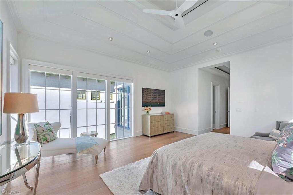 982 9th Avenue South Naples, FL 34102 - Photo 17 of 48 a bedroom with a large bed and a flat screen tv