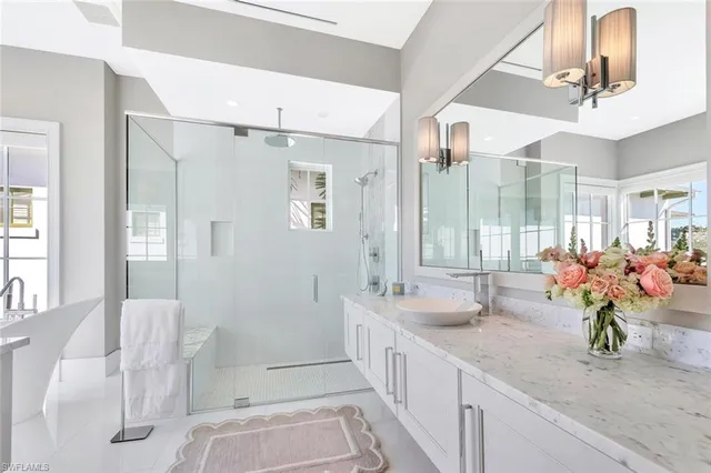 a spacious bathroom with a double vanity sink mirror and shower