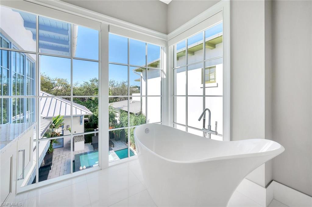 982 9th Avenue South Naples, FL 34102 - Photo 20 of 48 a dining room with a table and chairs