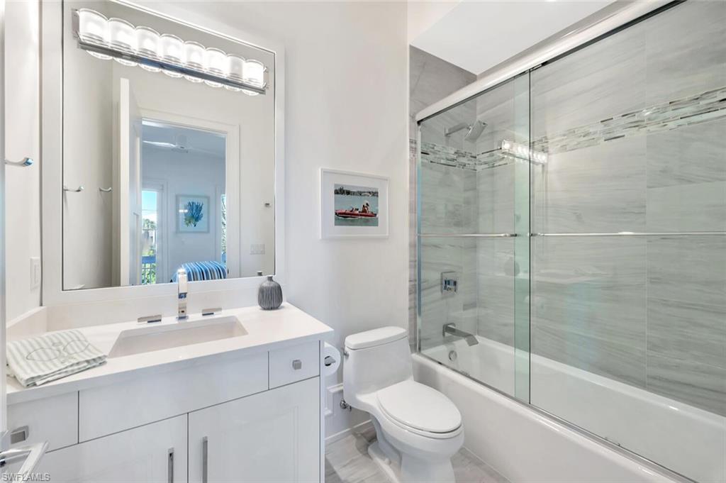 982 9th Avenue South Naples, FL 34102 - Photo 25 of 48 a bathroom with a granite countertop sink toilet and shower
