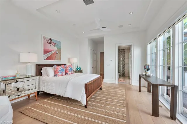 a bedroom with a large bed and a large window