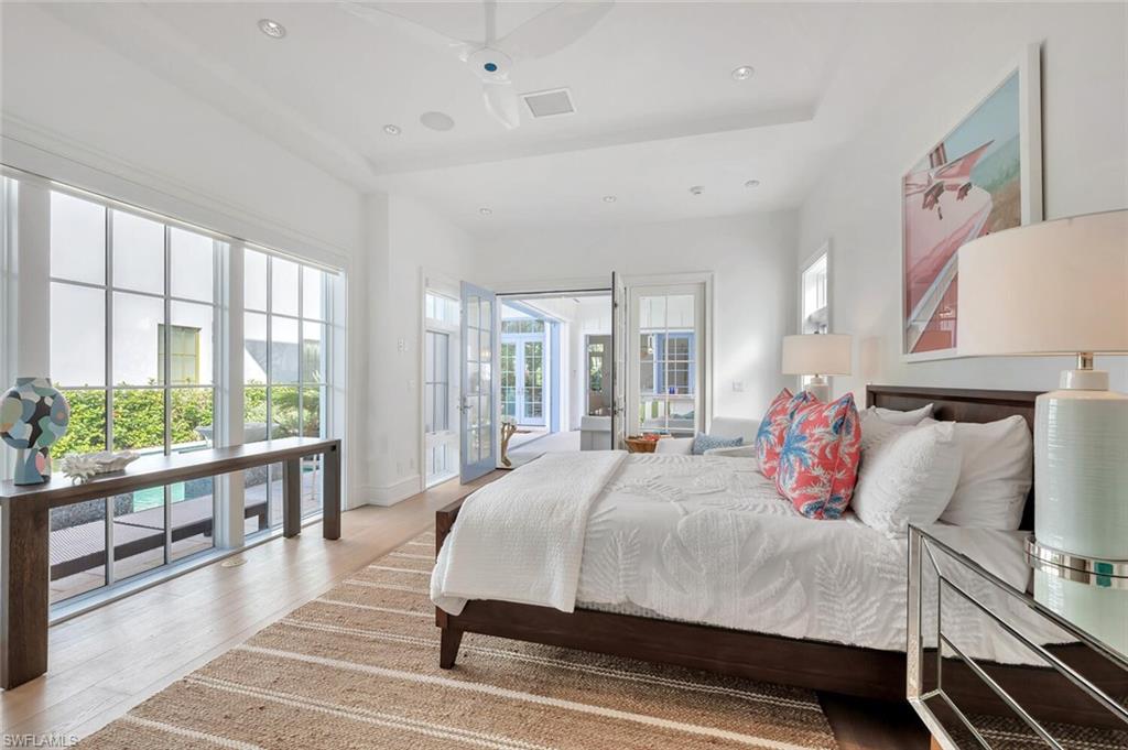982 9th Avenue South Naples, FL 34102 - Photo 27 of 48 a bedroom with a large bed and a large window