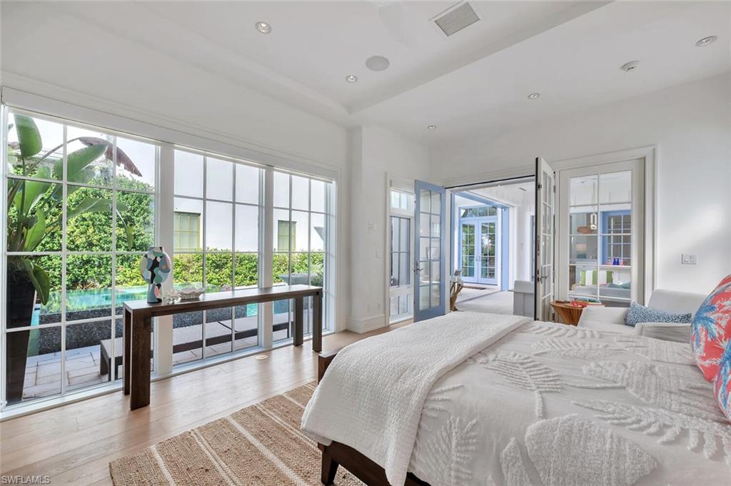 982 9th Avenue South Naples, FL 34102 - Photo 28 of 48 a bedroom with large window and wooden floor