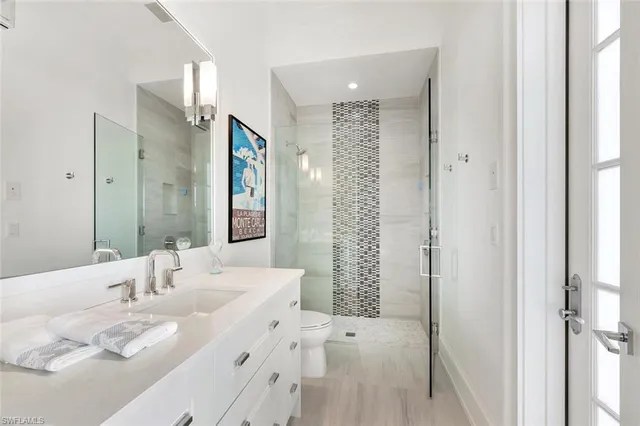 a kitchen with white cabinets and sink