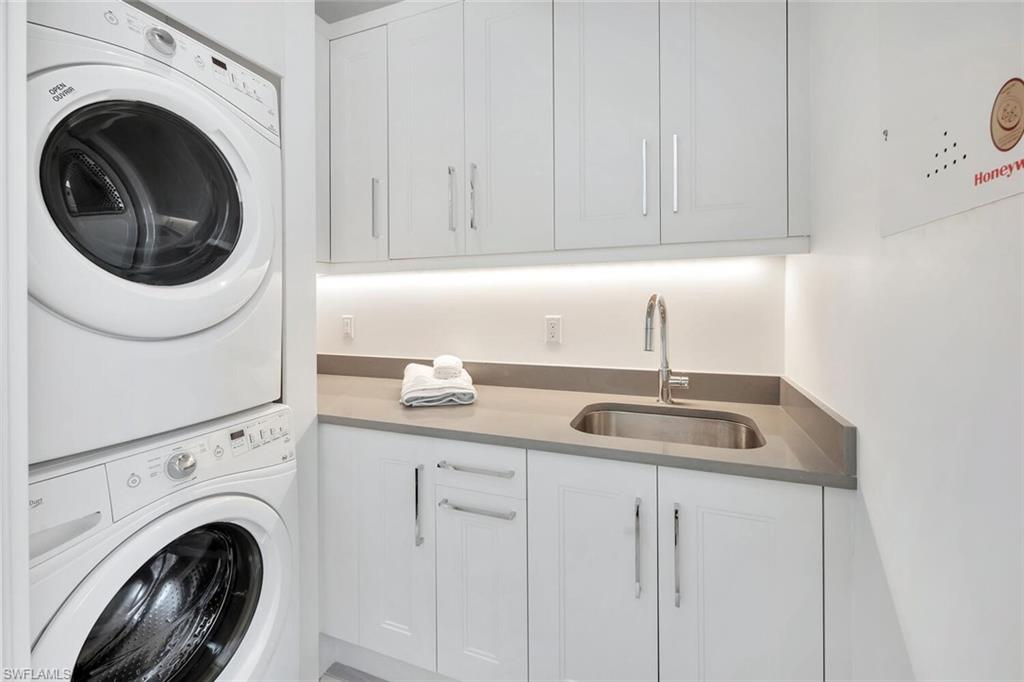 982 9th Avenue South Naples, FL 34102 - Photo 30 of 48 a kitchen with white cabinets and sink