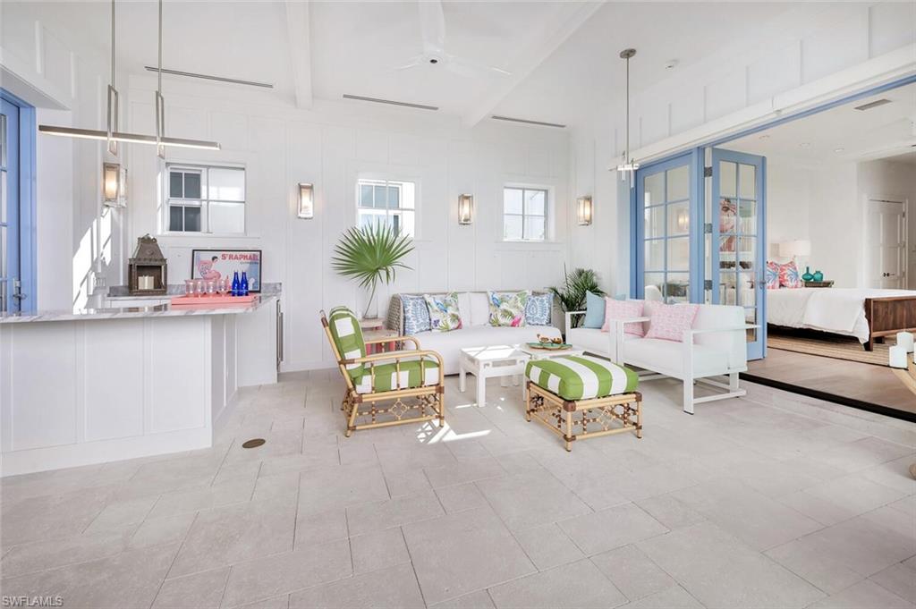 982 9th Avenue South Naples, FL 34102 - Photo 32 of 48 a living room with furniture and a chandelier