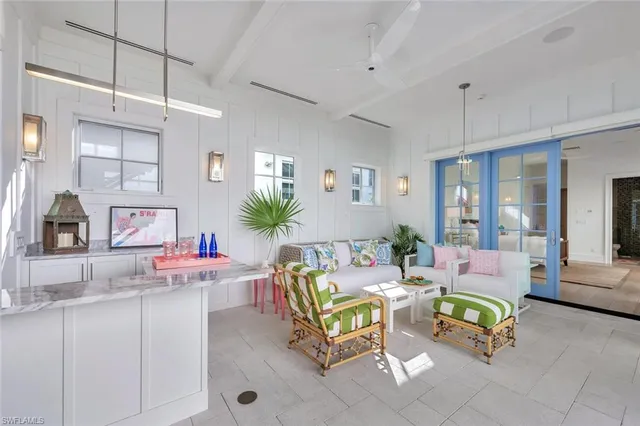 a living room with furniture and floor to ceiling windows
