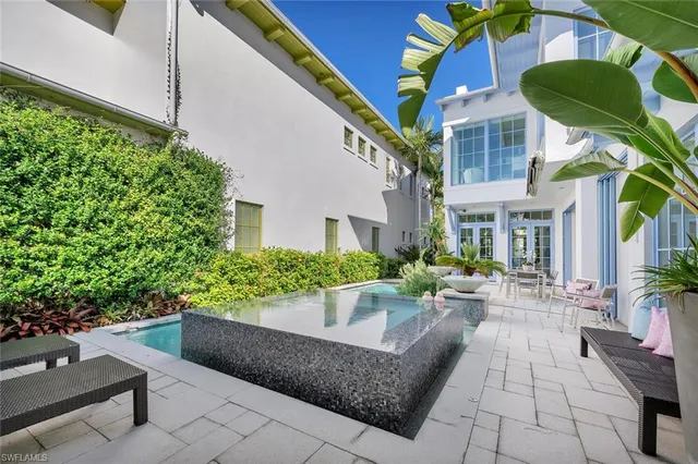 a view of a patio with chair and potted plants