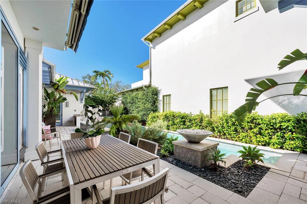 982 9th Avenue South Naples, FL 34102 - Photo 41 of 48 a view of a patio with chair and potted plants