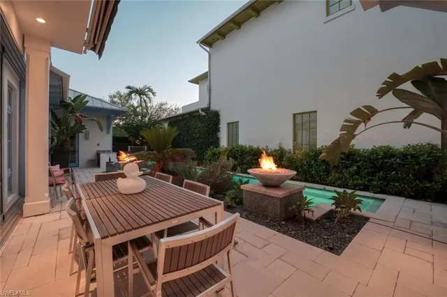 a view of a house with backyard porch and sitting area