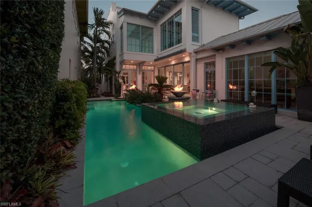 a view of a house with backyard sitting area and garden