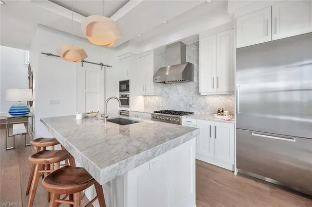 a kitchen with a stove a refrigerator and a sink