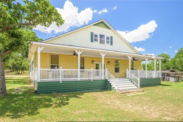a view of a house with a backyard