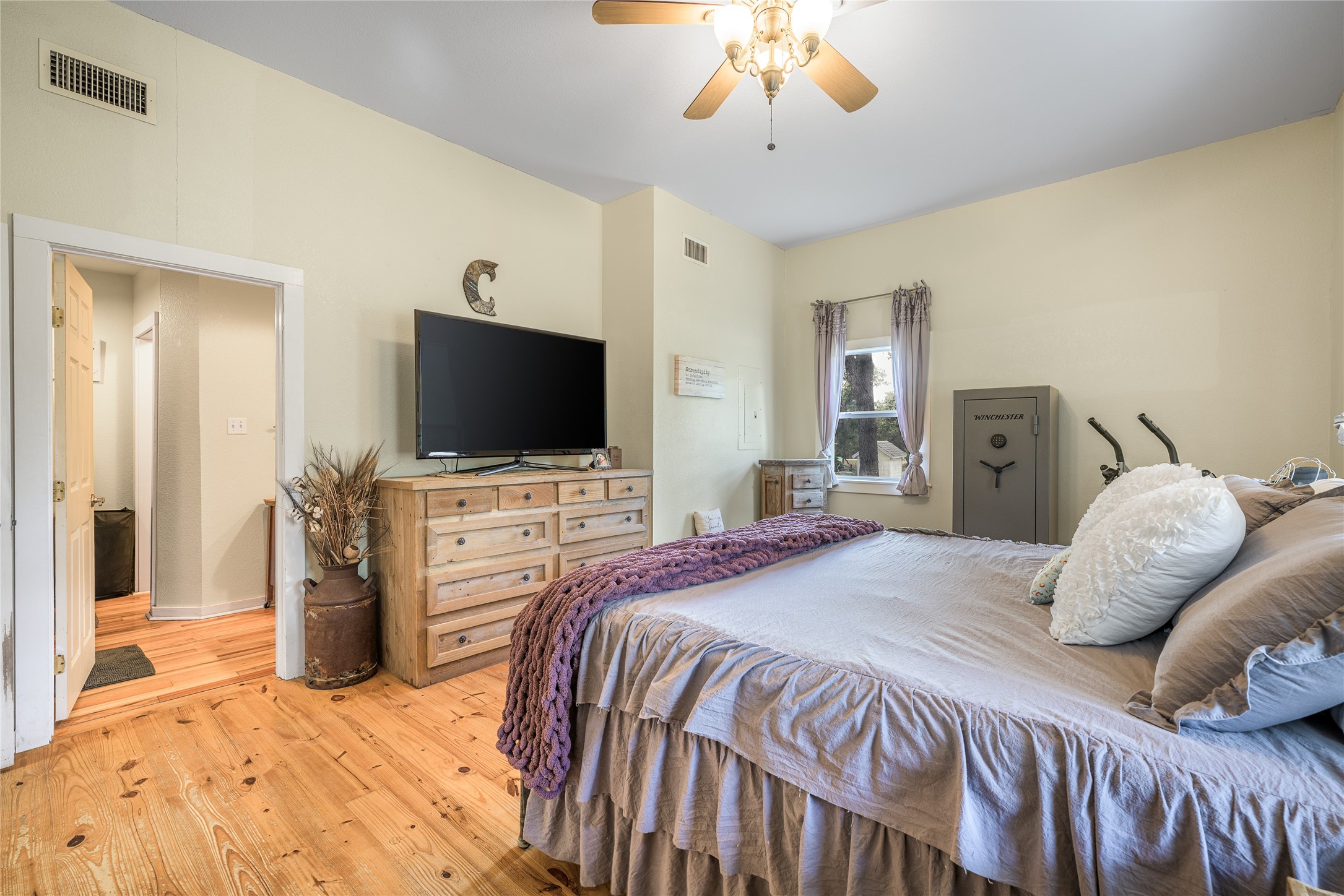 4310 Leslie Road Fayetteville, TX 78940 - Photo 12 of 22 a bedroom with a bed and a flat tv screen on dresser
