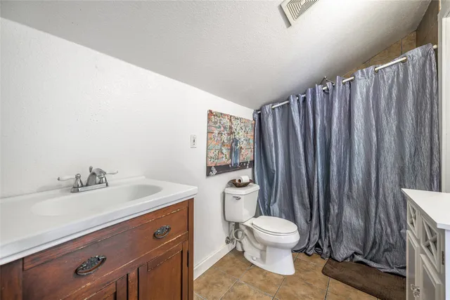 a bathroom with a toilet a sink and a mirror