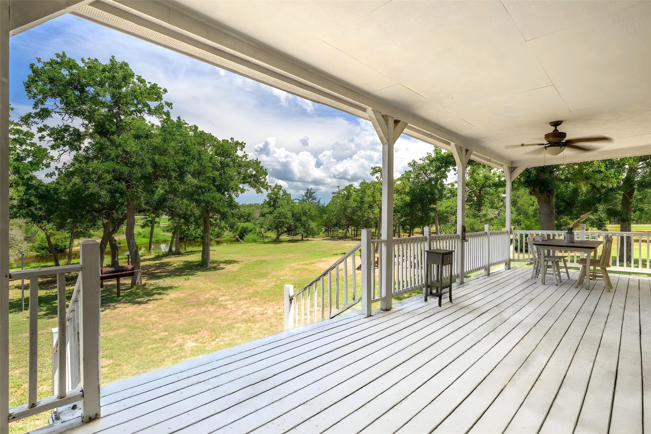 4310 Leslie Road Fayetteville, TX 78940 - Photo 5 of 22 a view of a balcony with chairs and wooden floor
