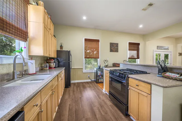 a kitchen with stainless steel appliances granite countertop a stove and a sink