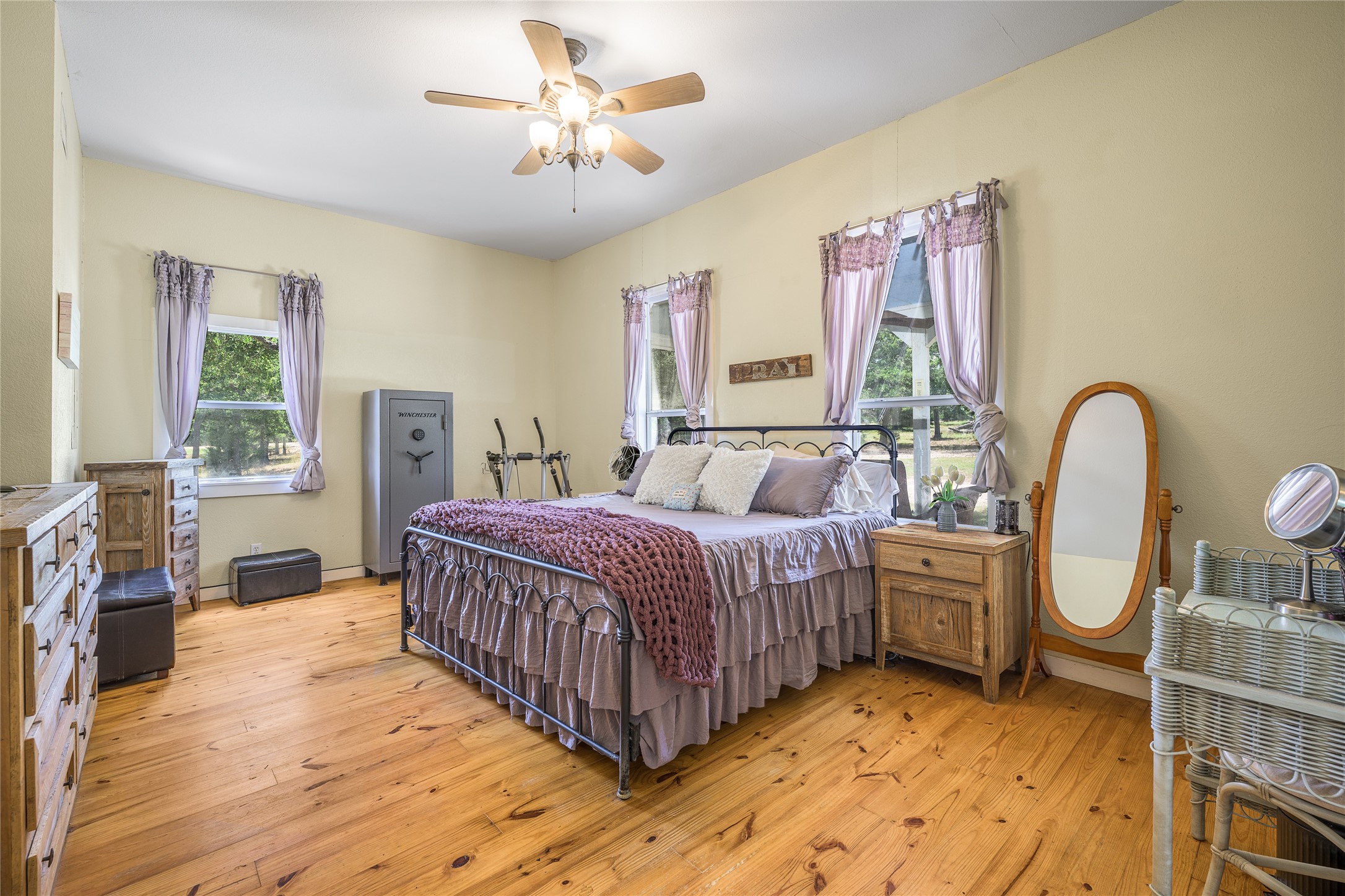 4310 Leslie Road Fayetteville, TX 78940 - Photo 10 of 22 a spacious bedroom with a bed wooden floor and window