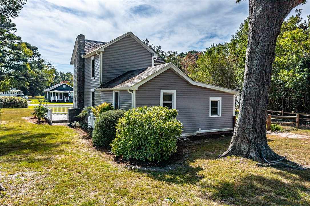 97 Virginia Road Irvington, VA 22480 - Photo 22 of 39 View of side of property featuring a chimney and a shingled roof