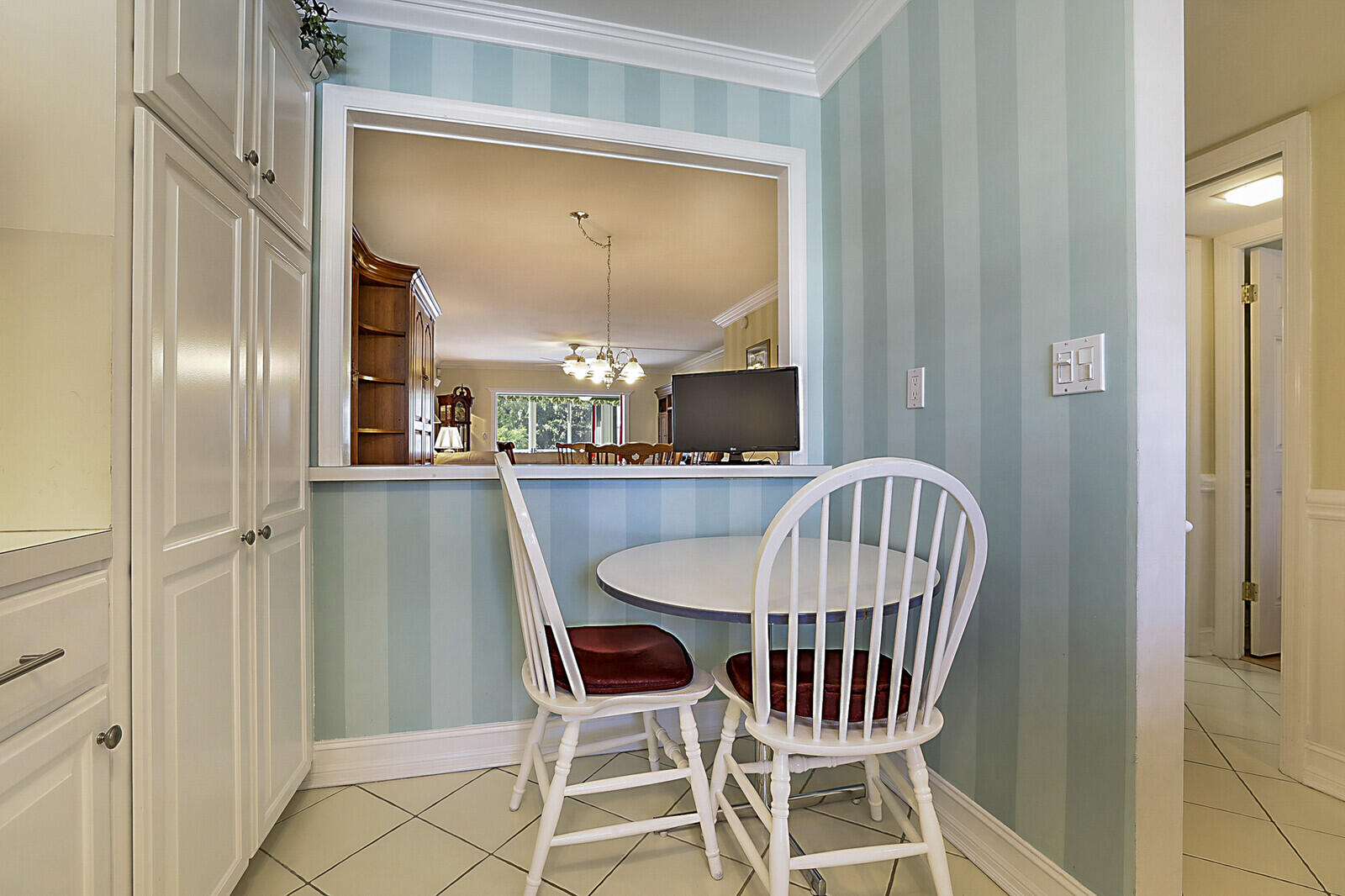700 Harbour Drive, Unit 2310 Boca Raton, FL 33431 - Photo 13 of 40 a view of a dining room with furniture a chandelier and wooden floor