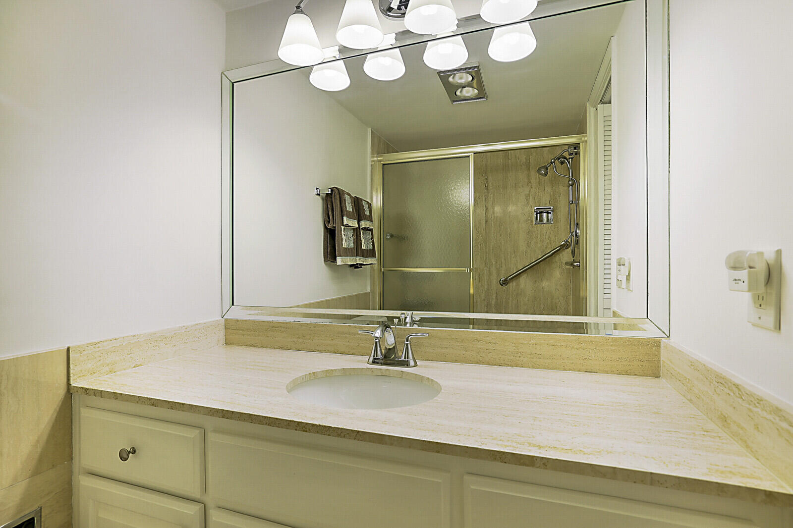 700 Harbour Drive, Unit 2310 Boca Raton, FL 33431 - Photo 22 of 40 a bathroom with a sink a mirror and a shower