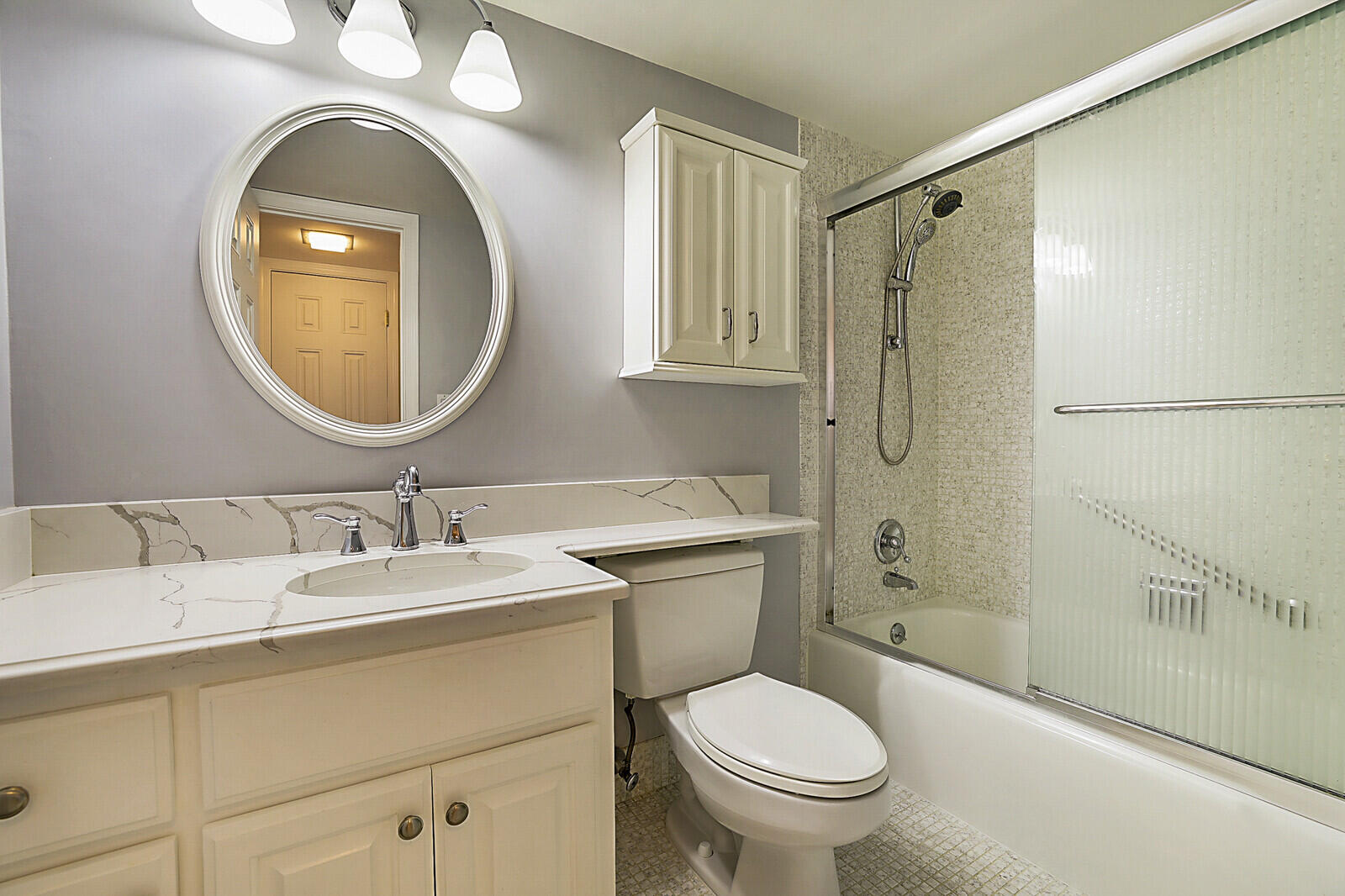 700 Harbour Drive, Unit 2310 Boca Raton, FL 33431 - Photo 26 of 40 a bathroom with a toilet a sink and a mirror