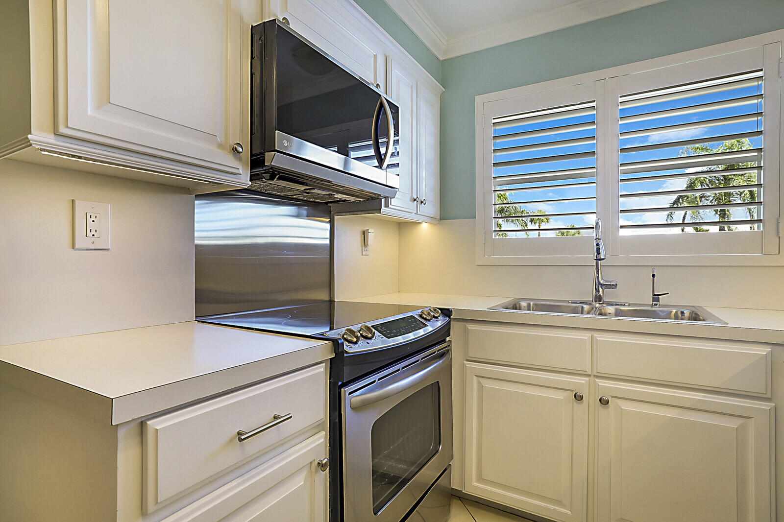 700 Harbour Drive, Unit 2310 Boca Raton, FL 33431 - Photo 6 of 40 a kitchen with stainless steel appliances white cabinets and a microwave oven