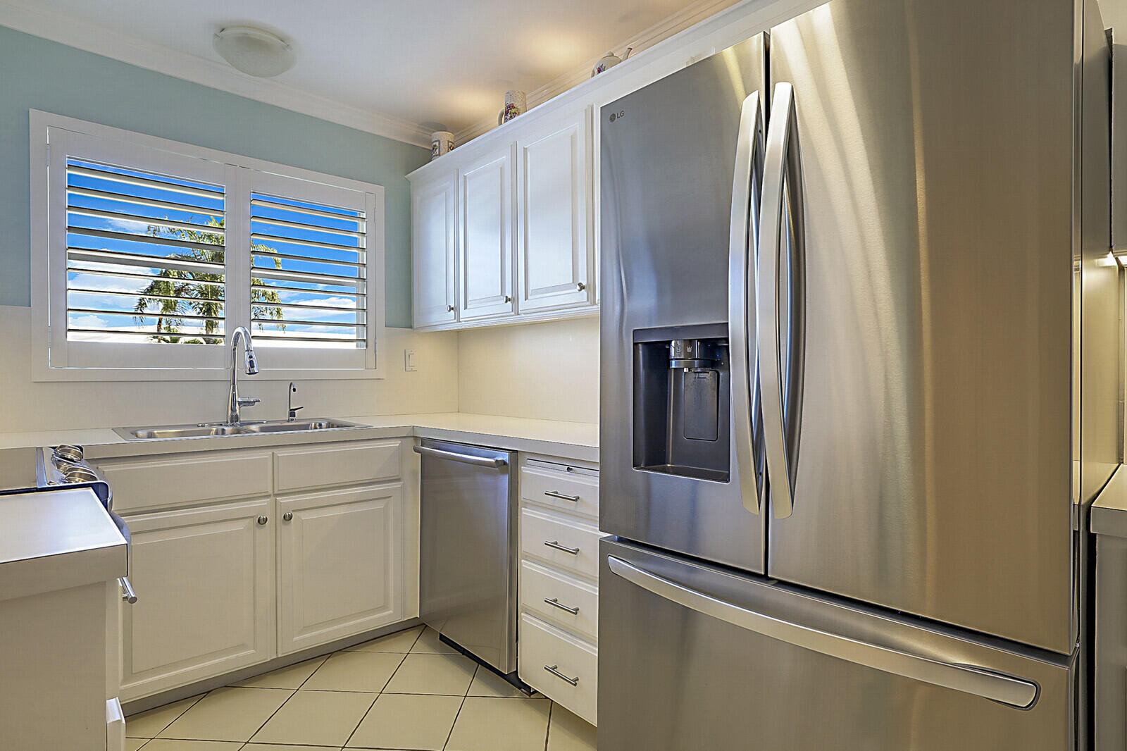 700 Harbour Drive, Unit 2310 Boca Raton, FL 33431 - Photo 7 of 40 a kitchen with white cabinets and white appliances