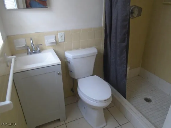a white toilet sitting next to a bathroom sink