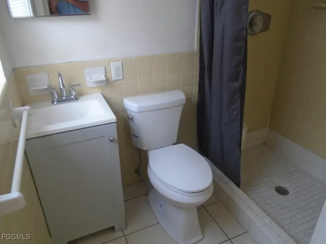 a white toilet sitting next to a bathroom sink