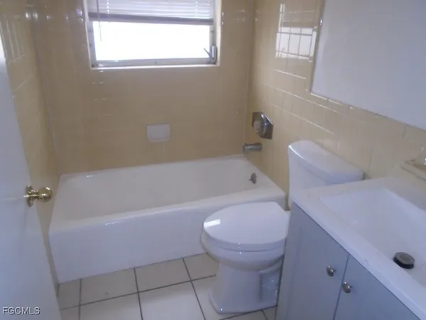 a bathroom with a sink a toilet and bathtub