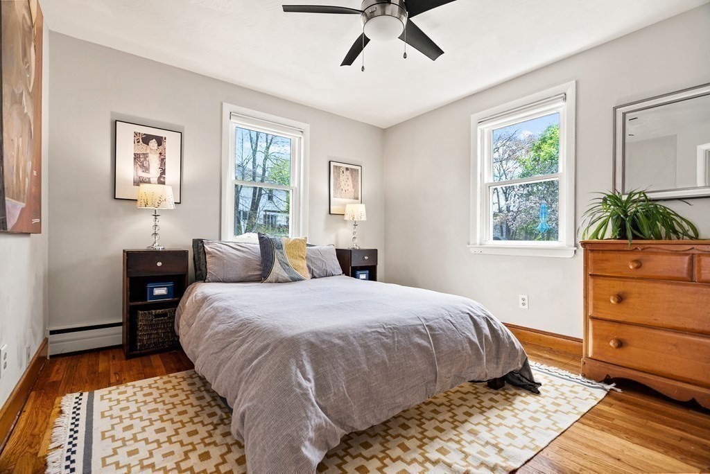 15 Dow Road Boston, MA 02132 - Photo 14 of 40 a bedroom with a bed and wooden floor