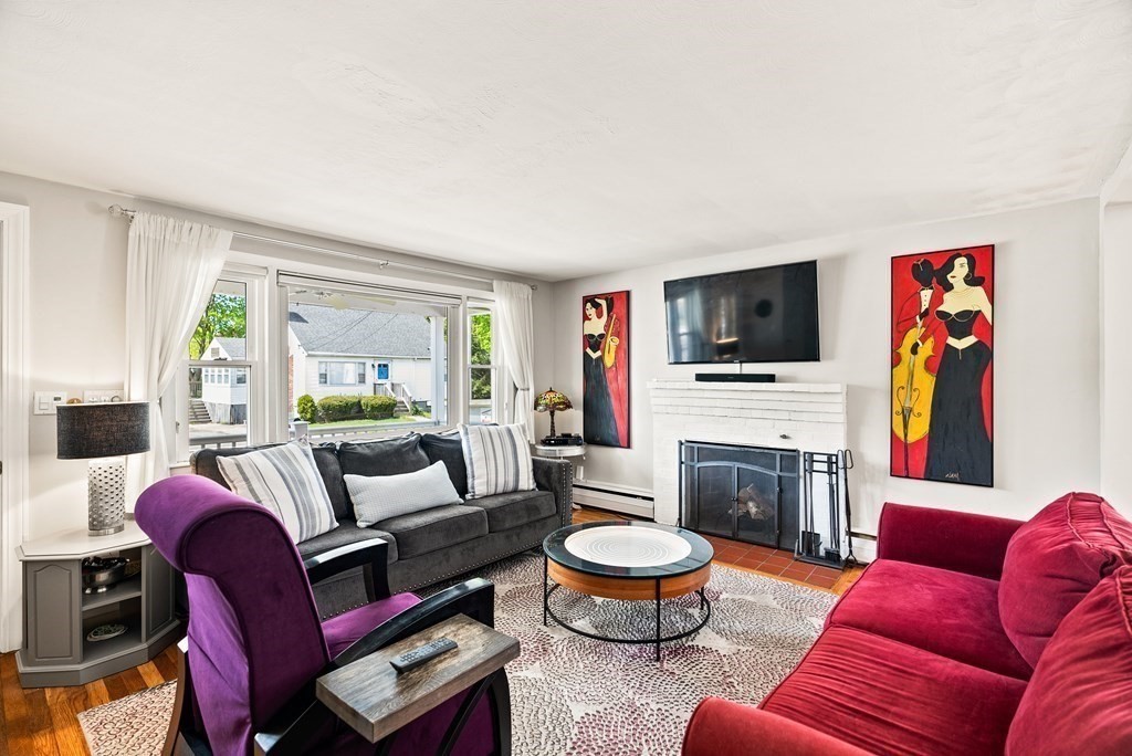 15 Dow Road Boston, MA 02132 - Photo 2 of 40 a living room with furniture a flat screen tv and a fireplace