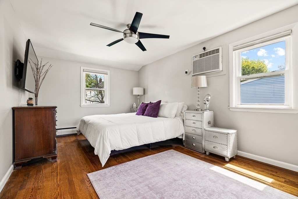 15 Dow Road Boston, MA 02132 - Photo 22 of 40 a bedroom with a bed a couch and a window