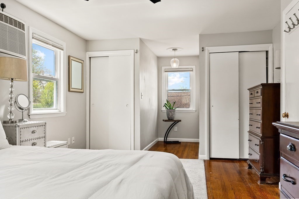 15 Dow Road Boston, MA 02132 - Photo 23 of 40 a bedroom with a bed and wooden floor