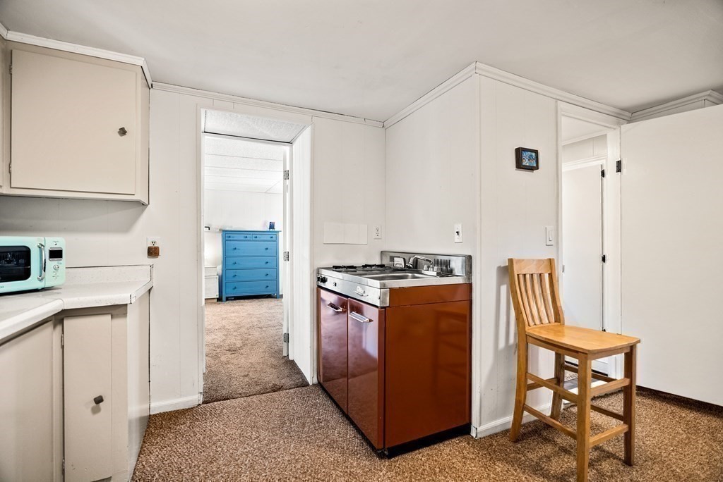 15 Dow Road Boston, MA 02132 - Photo 29 of 40 a kitchen with stainless steel appliances granite countertop a stove a sink and a refrigerator