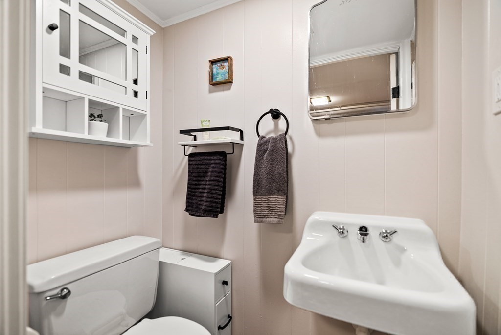 15 Dow Road Boston, MA 02132 - Photo 30 of 40 a bathroom with a toilet sink and mirror