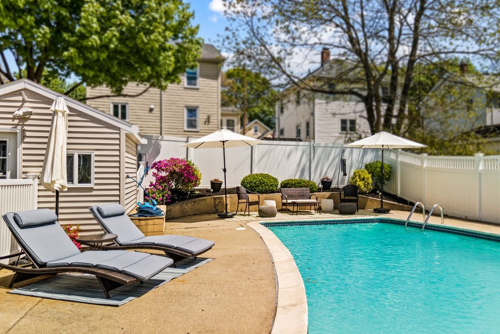 15 Dow Road Boston, MA 02132 - Photo 34 of 40 a view of a patio with table and chairs under an umbrella