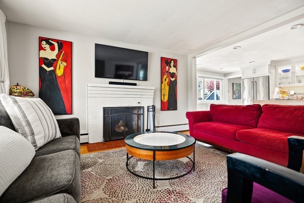 15 Dow Road Boston, MA 02132 - Photo 4 of 40 a living room with furniture a flat screen tv and a fireplace