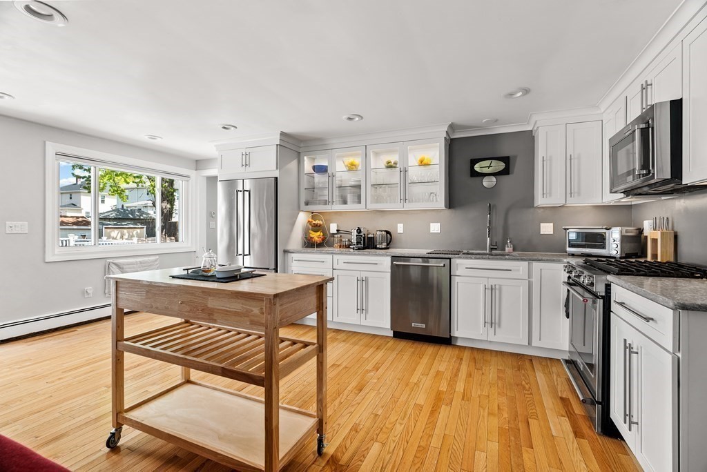 15 Dow Road Boston, MA 02132 - Photo 6 of 40 a kitchen with a sink cabinets and window