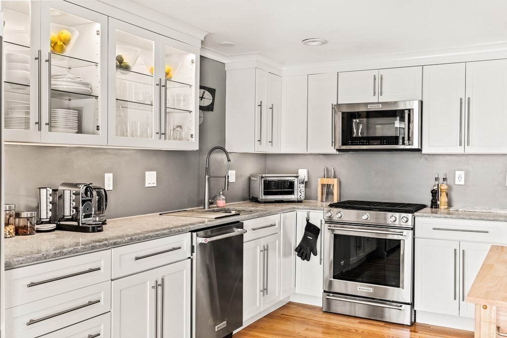 15 Dow Road Boston, MA 02132 - Photo 7 of 40 a kitchen with cabinets stainless steel appliances and a sink