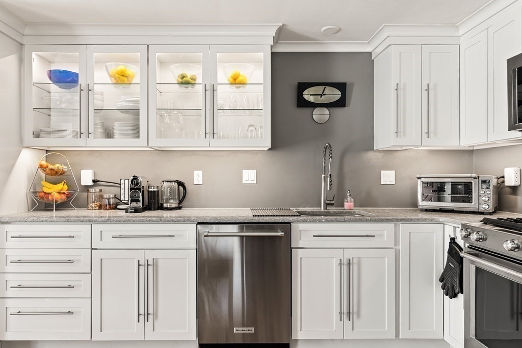 15 Dow Road Boston, MA 02132 - Photo 8 of 40 a kitchen with granite countertop white cabinets and stainless steel appliances