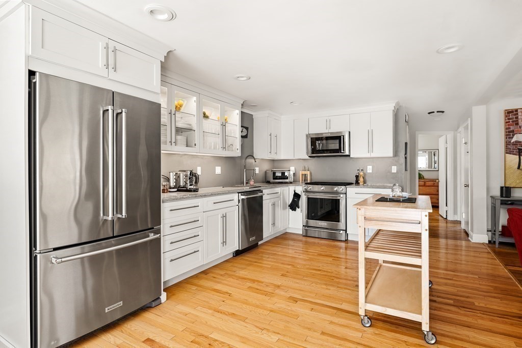15 Dow Road Boston, MA 02132 - Photo 9 of 40 a kitchen with granite countertop a refrigerator stove and oven