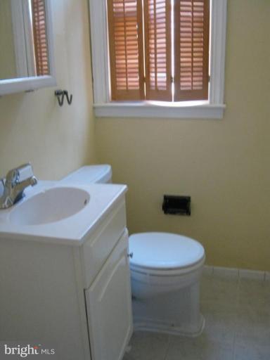 4915 Cedar Garden Road Baltimore, MD 21229 - Photo 5 of 10 a bathroom with a sink a toilet and a window